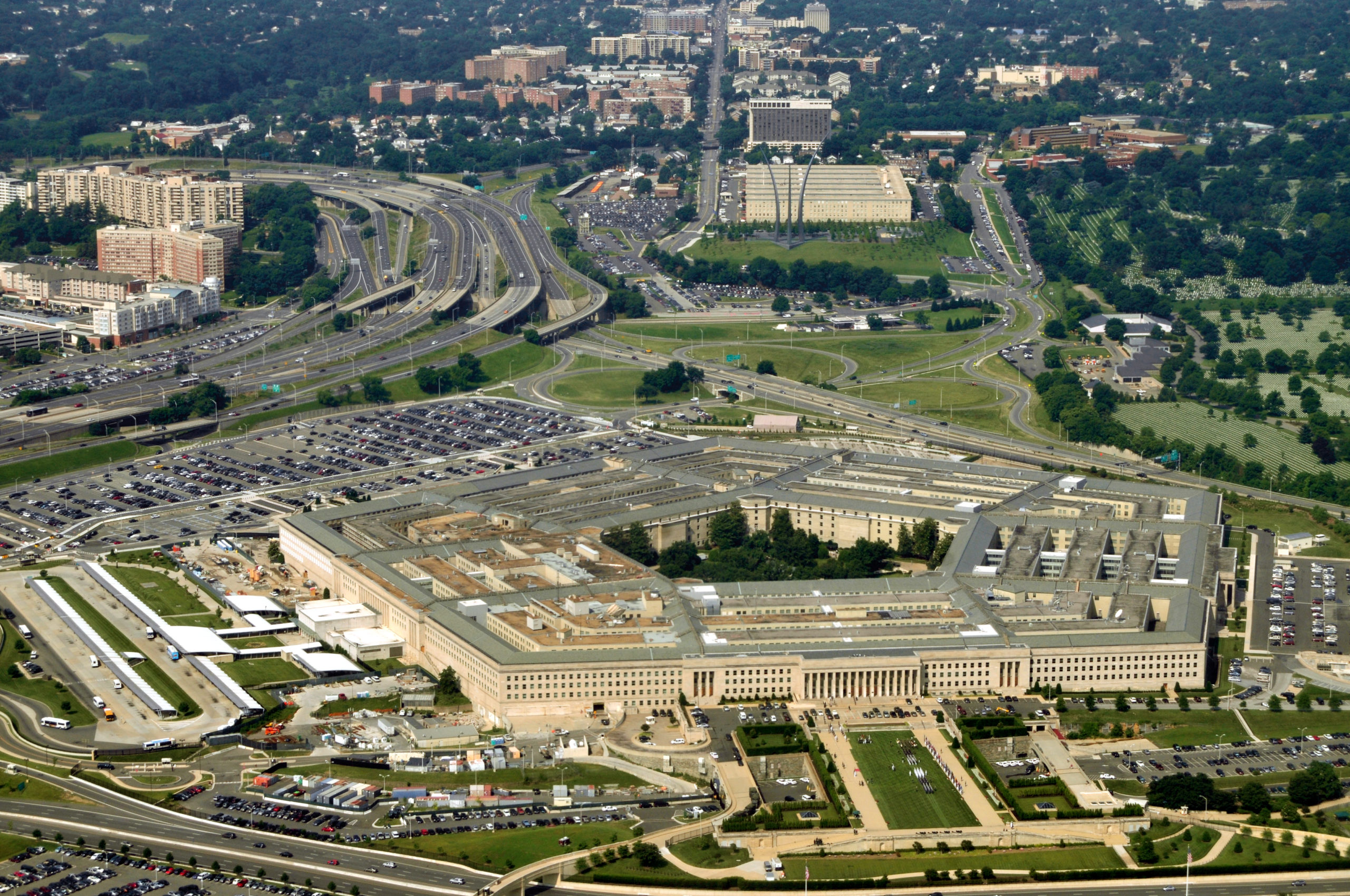 Aerial view of the Pentagon's five-sided structure surrounded by parking lots, highways, and the surrounding Arlington