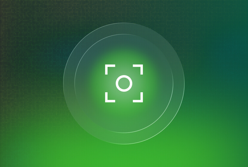 White camera focus icon centered within concentric circles on a green gradient background.